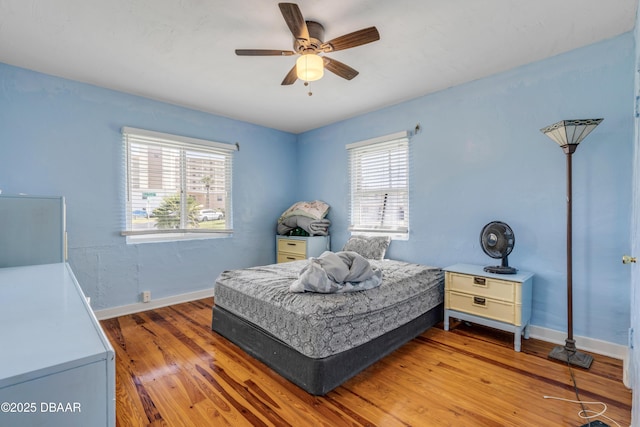 327 Due E St, New Smyrna Beach, FL 32169 - bedroom featuring wood finished floors, baseboards, and ceiling fan
