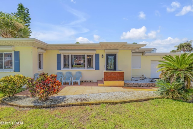 327 Due E St, New Smyrna Beach, FL 32169 - view of front of property with stucco siding