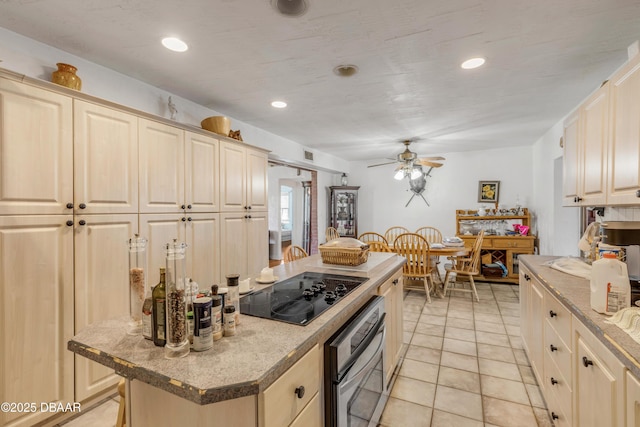 327 Due E St, New Smyrna Beach, FL 32169 - kitchen with oven, black electric stovetop, a ceiling fan, recessed lighting, and a center island