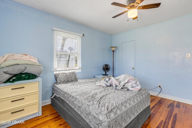 327 Due E St, New Smyrna Beach, FL 32169 - bedroom with wood finished floors, baseboards, and a ceiling fan