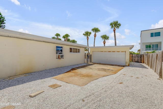 327 Due E St, New Smyrna Beach, FL 32169 - view of front of house with stucco siding and a garage