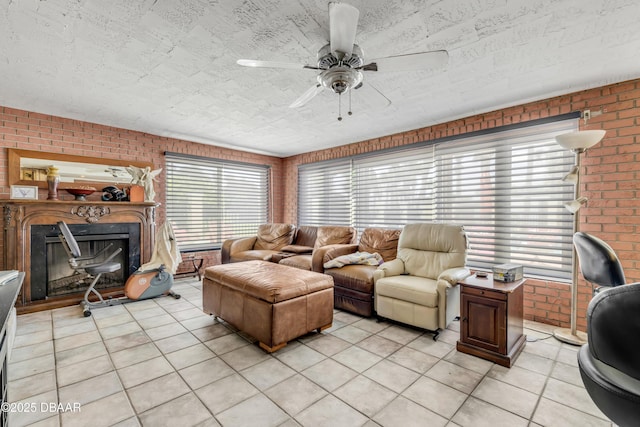 327 Due E St, New Smyrna Beach, FL 32169 - living area featuring light tile patterned floors, brick wall, a ceiling fan, and a fireplace