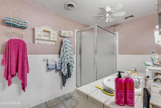 327 Due E St, New Smyrna Beach, FL 32169 - full bath with tile walls, ceiling fan, a shower stall, and wainscoting