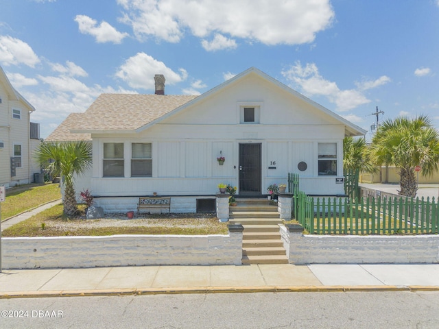 bungalow-style home with a front lawn