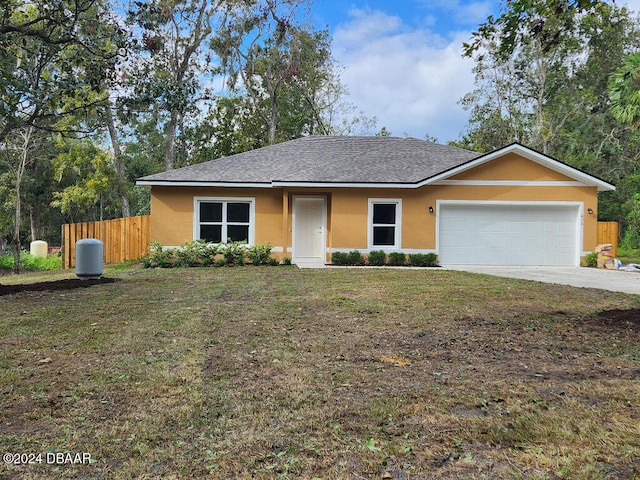 single story home featuring a garage and a front lawn