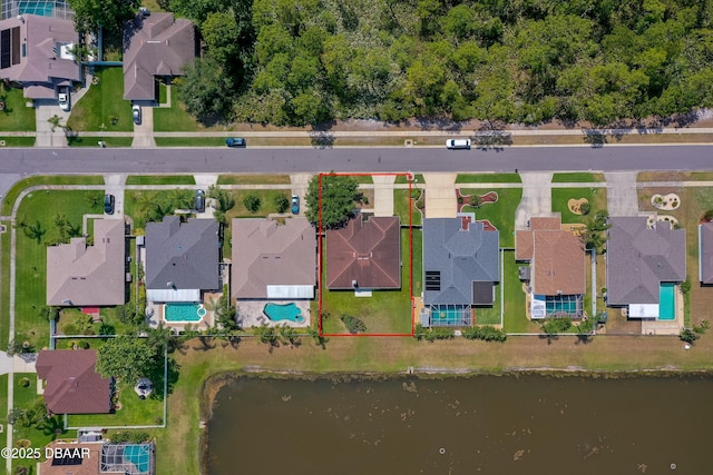 drone / aerial view featuring a water view and a residential view