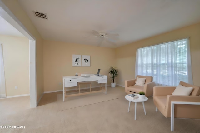 sitting room featuring baseboards, carpet, a ceiling fan, and visible vents