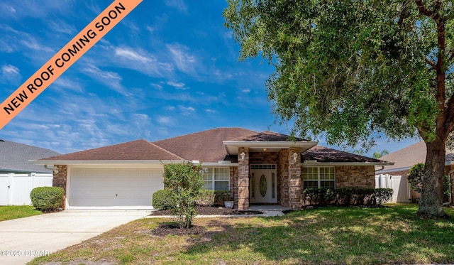 view of front of home with a garage, fence, concrete driveway, and a front yard