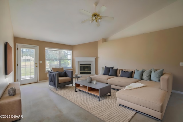 living room featuring a ceiling fan, baseboards, vaulted ceiling, and light carpet