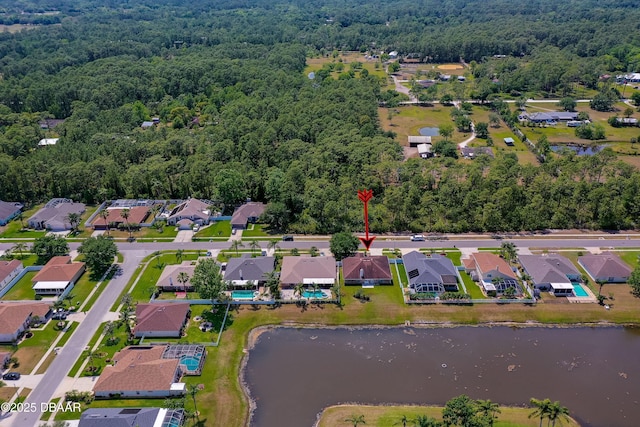 bird's eye view featuring a water view, a residential view, and a forest view
