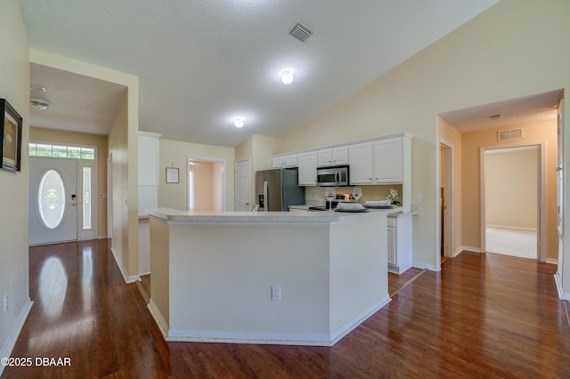 kitchen featuring dark wood-style flooring, stainless steel appliances, baseboards, white cabinetry, and visible vents