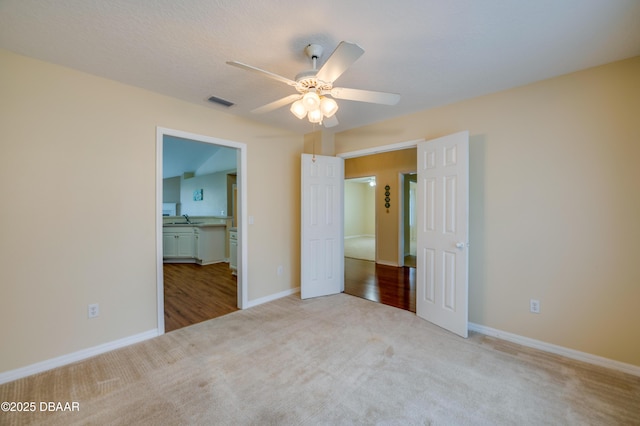 unfurnished bedroom featuring carpet floors, baseboards, and visible vents