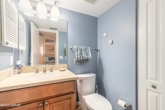 bathroom featuring vanity and toilet