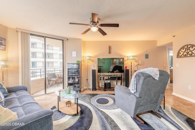 living room featuring light tile patterned floors, ceiling fan, and expansive windows