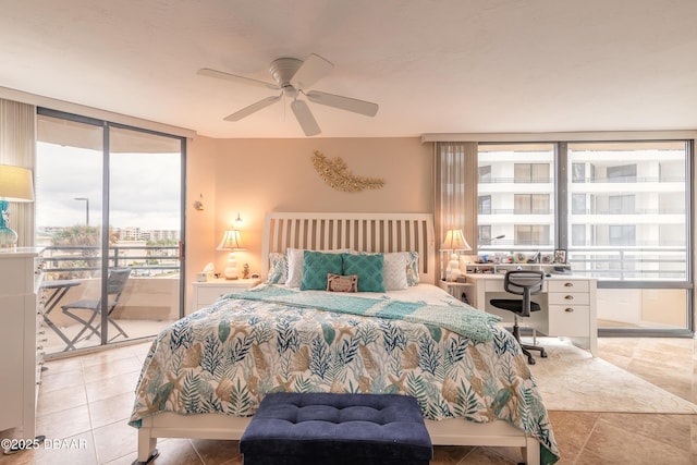 bedroom with light tile patterned floors, access to exterior, expansive windows, and ceiling fan