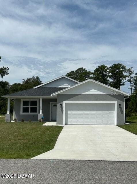 view of front of property with a front yard and a garage