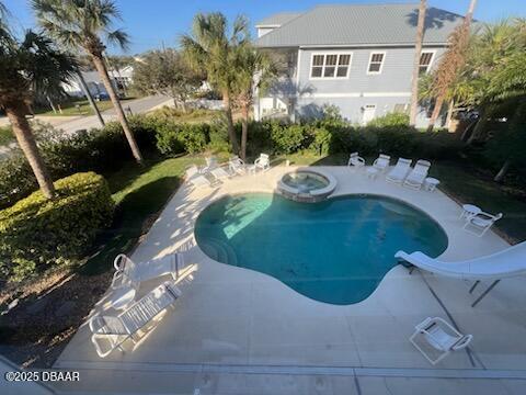610 S Atlantic Ave, New Smyrna Beach, FL 32169 - view of pool with a patio and a pool with connected hot tub