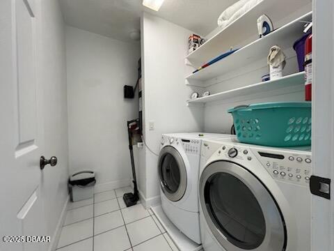 610 S Atlantic Ave, New Smyrna Beach, FL 32169 - laundry area with independent washer and dryer, light tile patterned flooring, and baseboards