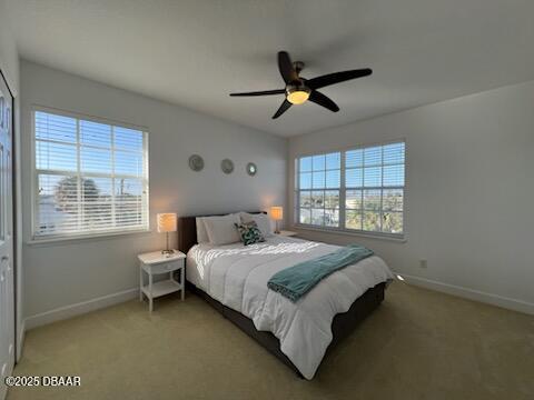 610 S Atlantic Ave, New Smyrna Beach, FL 32169 - bedroom featuring baseboards, light carpet, and a ceiling fan