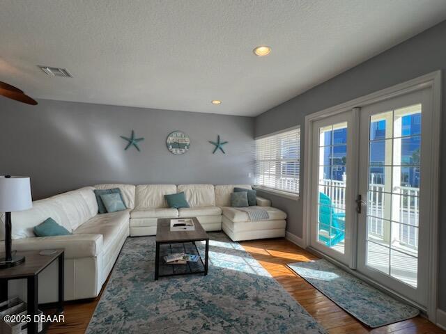 610 S Atlantic Ave, New Smyrna Beach, FL 32169 - living area featuring wood finished floors, a ceiling fan, recessed lighting, baseboards, and a textured ceiling