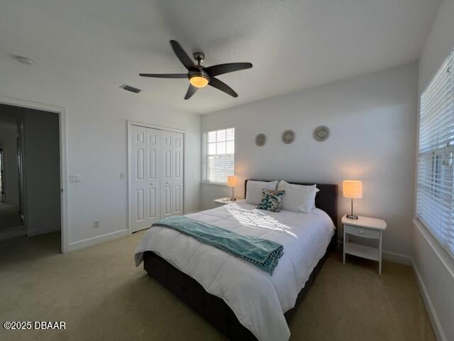 610 S Atlantic Ave, New Smyrna Beach, FL 32169 - bedroom featuring multiple windows, light colored carpet, and a closet