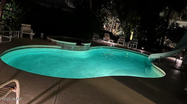 610 S Atlantic Ave, New Smyrna Beach, FL 32169 - view of pool with a water slide, a patio area, and a pool with connected hot tub