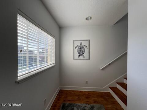 610 S Atlantic Ave, New Smyrna Beach, FL 32169 - staircase with wood finished floors and baseboards