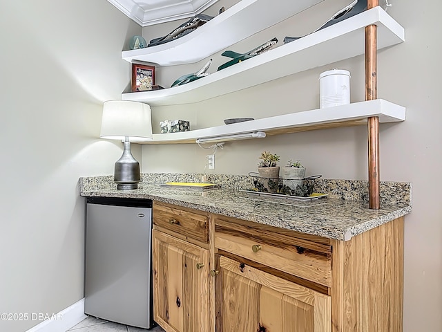 2055 S Atlantic Ave S Unit 1410, Daytona Beach, FL 32118 - kitchen with open shelves, stainless steel fridge, crown molding, light stone counters, and light tile patterned flooring