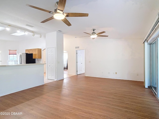 6037 Whispering Trees Ln, Port Orange, FL 32128 - unfurnished living room with ceiling fan, baseboards, wood finished floors, and visible vents