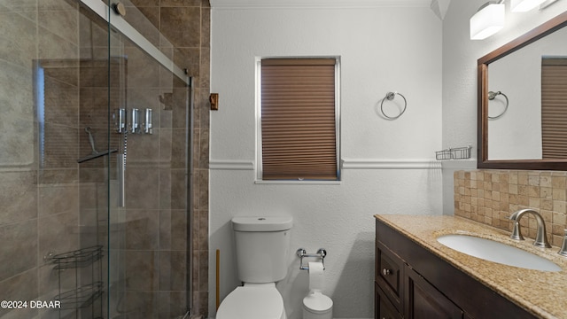 bathroom with vanity, toilet, backsplash, and walk in shower