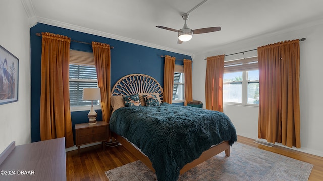 bedroom with ceiling fan, crown molding, a water view, and hardwood / wood-style flooring