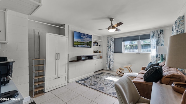 tiled living room featuring ceiling fan