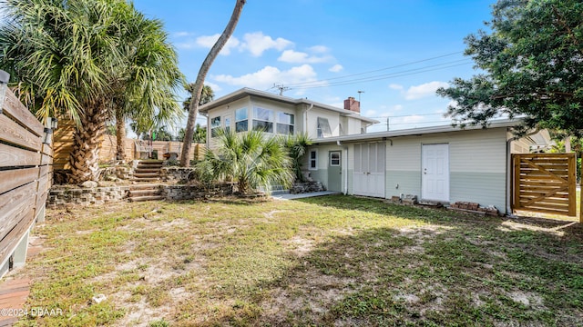 131 Mitchell Pl, Daytona Beach, FL 32118 - rear view of house featuring a chimney