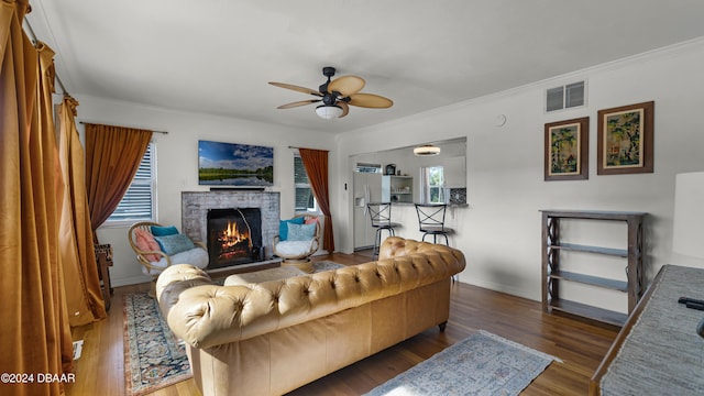 131 Mitchell Pl, Daytona Beach, FL 32118 - living area with ceiling fan, plenty of natural light, a fireplace, crown molding, and wood finished floors