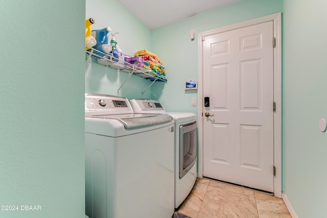 clothes washing area with washer and clothes dryer