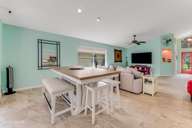 dining area featuring ceiling fan with notable chandelier and plenty of natural light