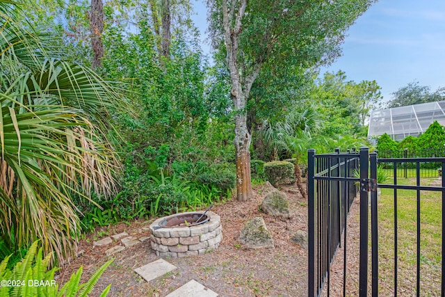 view of gate featuring a fire pit