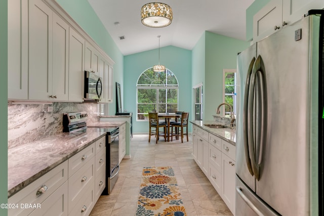 kitchen featuring white cabinetry, appliances with stainless steel finishes, sink, and pendant lighting