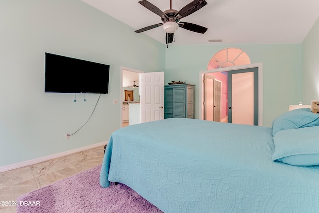 bedroom featuring lofted ceiling, ceiling fan, and ensuite bath