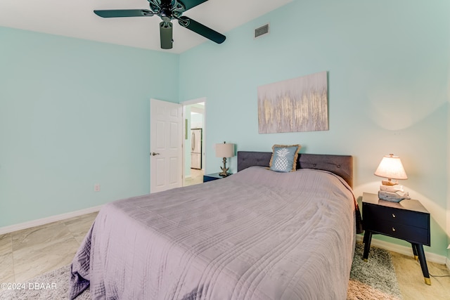 bedroom with ceiling fan and fridge