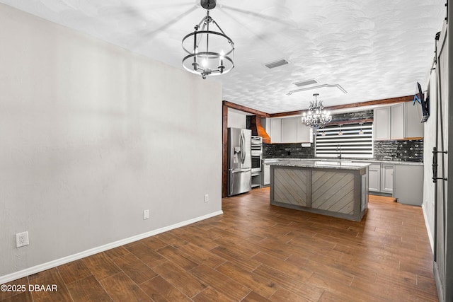 32 Twin River Dr, Ormond Beach, FL 32174 - kitchen with an inviting chandelier, stainless steel fridge, wall chimney exhaust hood, baseboards, and backsplash