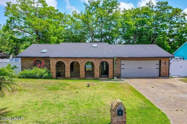 32 Twin River Dr, Ormond Beach, FL 32174 - view of front of home with a front yard, brick siding, fence, concrete driveway, and an attached garage