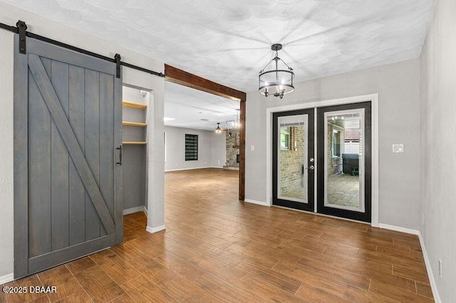 32 Twin River Dr, Ormond Beach, FL 32174 - interior space featuring baseboards, wood finished floors, a barn door, and a chandelier