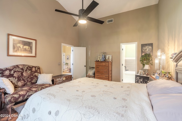 bedroom with ceiling fan, ensuite bath, and high vaulted ceiling