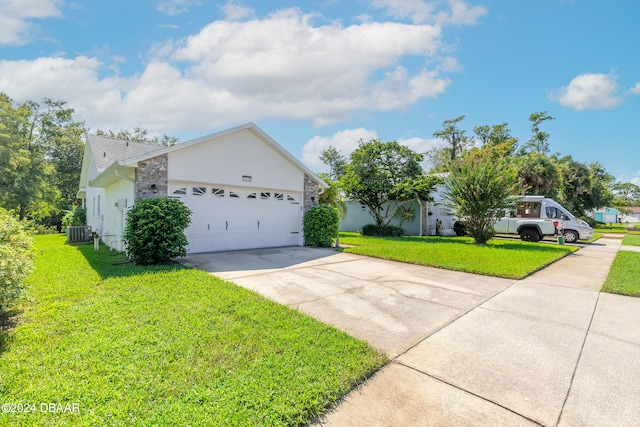 ranch-style house with a garage, central air condition unit, and a front yard