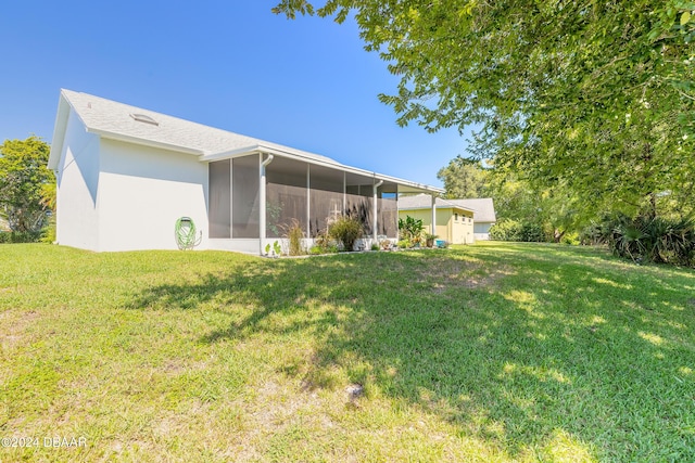 3836 Long Grove Ln, Port Orange, FL 32129 - back of property with a sunroom, a yard, and stucco siding