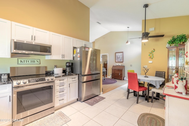3836 Long Grove Ln, Port Orange, FL 32129 - kitchen with stainless steel appliances, high vaulted ceiling, white cabinetry, a ceiling fan, and light tile patterned floors