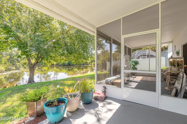 sunroom / solarium with a water view