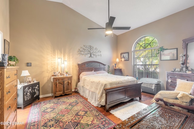 bedroom featuring high vaulted ceiling, wood-type flooring, and ceiling fan