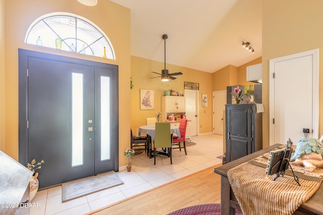 entrance foyer featuring light wood-type flooring, ceiling fan, and high vaulted ceiling